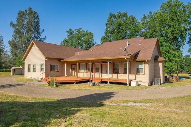 7899 Elmers Way, Shingletown, CA 96088 - rear view of property featuring a yard, a shed, an outbuilding, and central air condition unit