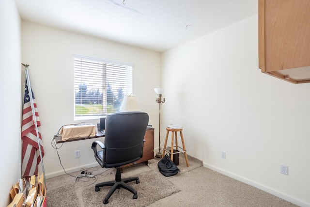 carpeted office featuring baseboards