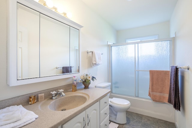 full bathroom featuring bath / shower combo with glass door, toilet, and vanity