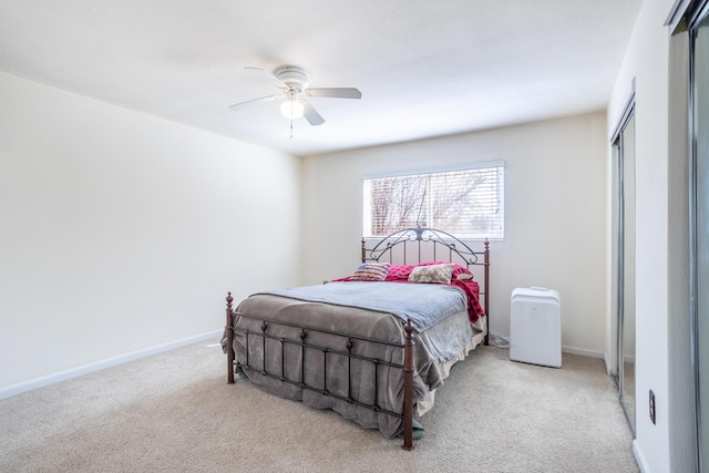 bedroom featuring a closet, ceiling fan, baseboards, and carpet floors