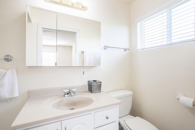 half bath featuring toilet and vanity