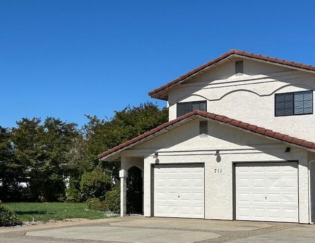 view of side of home featuring a garage