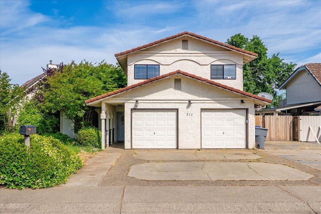 711 Teakwood Dr, Redding, CA 96003 - view of front facade featuring a tiled roof, a garage, stucco siding, and concrete driveway