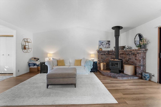 711 Teakwood Dr, Redding, CA 96003 - living room featuring wood finished floors, a wood stove, and baseboards