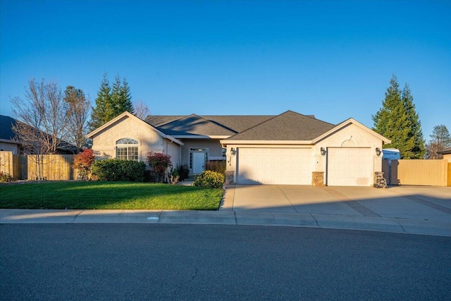 ranch-style home featuring a garage and a front yard