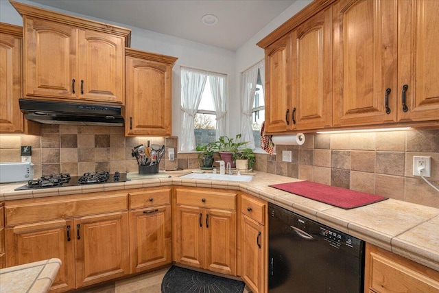 kitchen with tasteful backsplash, tile countertops, dishwasher, and gas cooktop