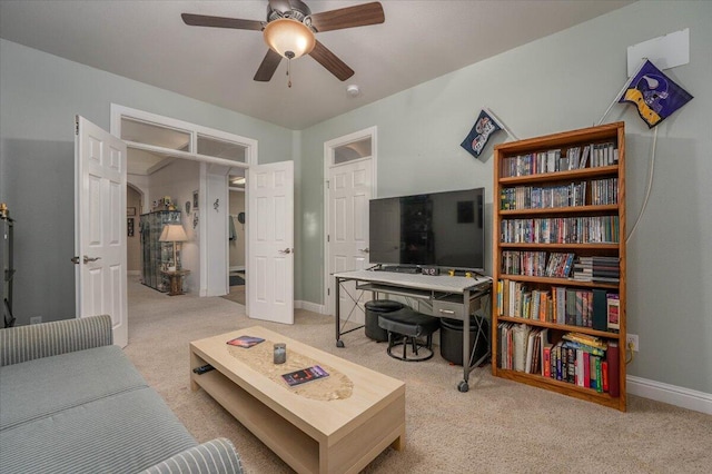 living room with ceiling fan and light colored carpet