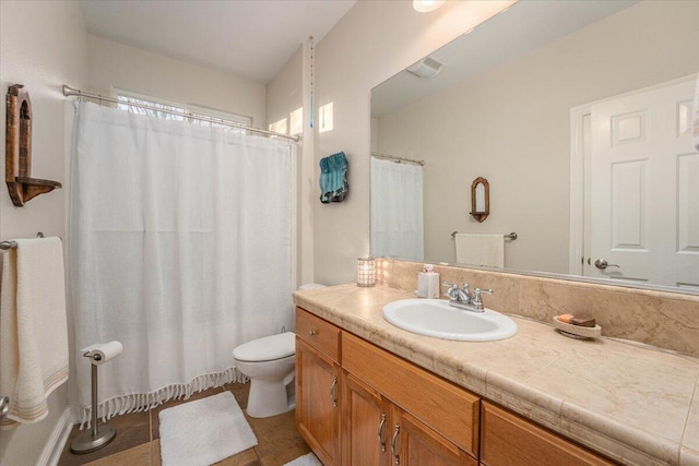 bathroom featuring toilet, vanity, and tile patterned floors