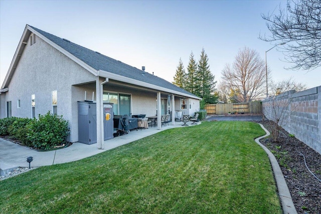 back of house featuring a yard and a patio area