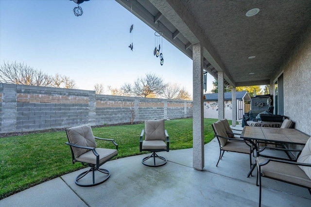 view of patio featuring a storage unit