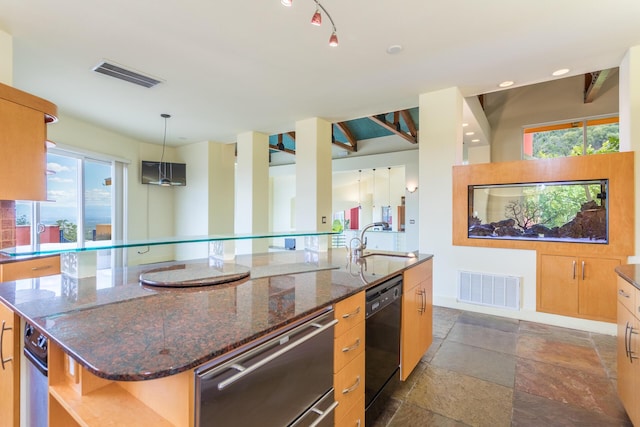 kitchen featuring sink, a center island with sink, dark stone counters, and black dishwasher