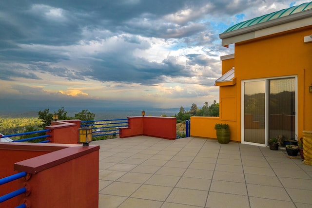 patio terrace at dusk with a balcony