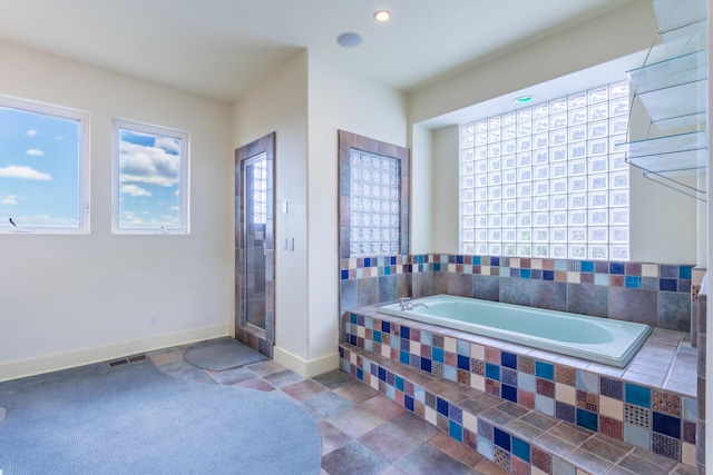 bathroom featuring tiled tub