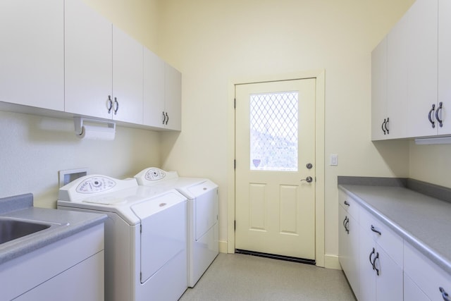 clothes washing area featuring cabinets and washing machine and dryer