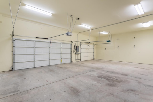 garage with electric panel and a garage door opener