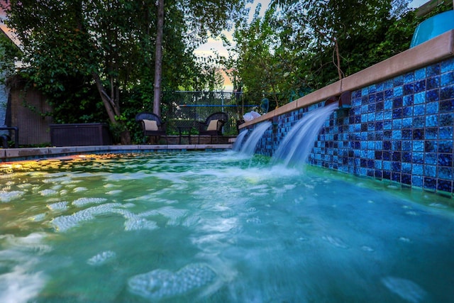 view of pool at dusk