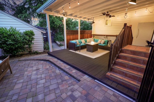 deck featuring an outdoor living space and ceiling fan