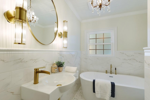 bathroom with sink, crown molding, a bathing tub, and a notable chandelier