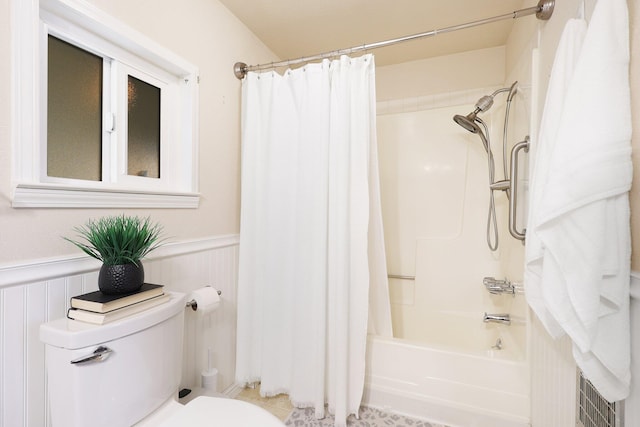 bathroom with toilet and shower / bath combo with shower curtain