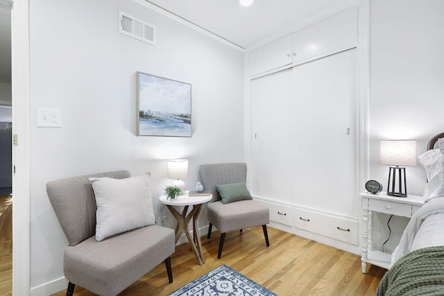 sitting room featuring light hardwood / wood-style flooring