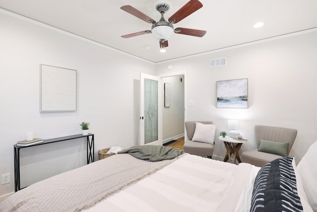 bedroom with ceiling fan, crown molding, and hardwood / wood-style floors