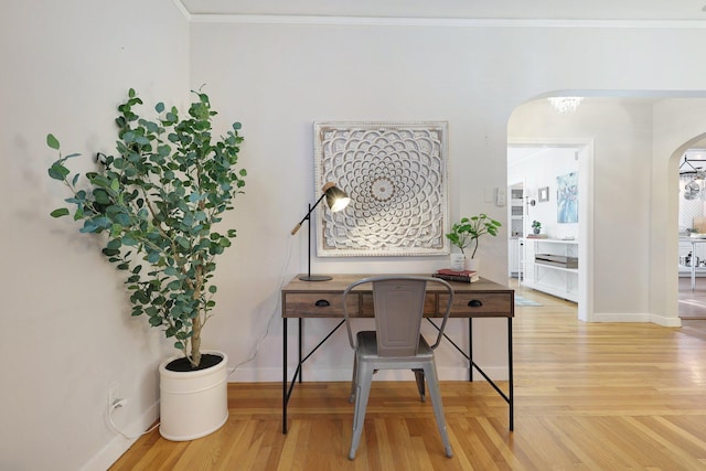 office with a notable chandelier, wood-type flooring, and crown molding