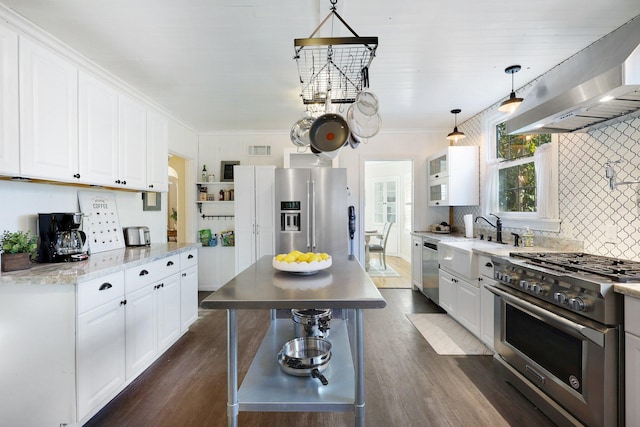 kitchen featuring white cabinetry, hanging light fixtures, exhaust hood, and appliances with stainless steel finishes