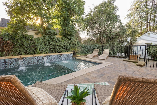 view of pool with pool water feature and a patio area