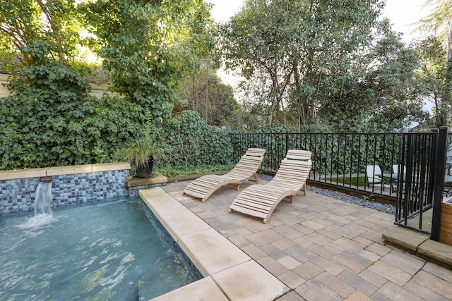 view of patio featuring pool water feature and a fenced in pool