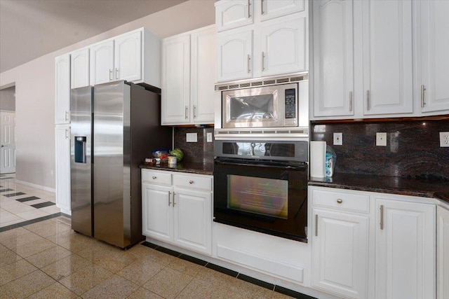 kitchen with white cabinets, appliances with stainless steel finishes, and tasteful backsplash