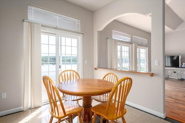 dining area with plenty of natural light and a water view