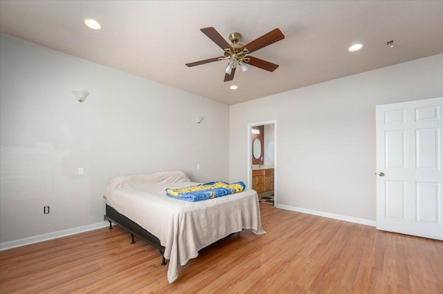 bedroom featuring ceiling fan, ensuite bathroom, and light hardwood / wood-style floors