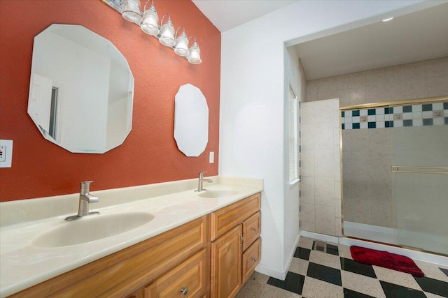 bathroom with a tile shower and vanity