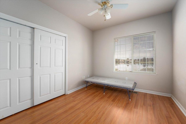 unfurnished bedroom with ceiling fan, a closet, and light hardwood / wood-style floors