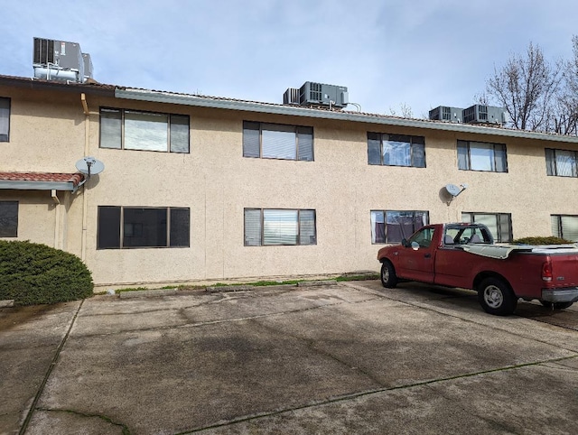 view of side of home featuring central AC unit