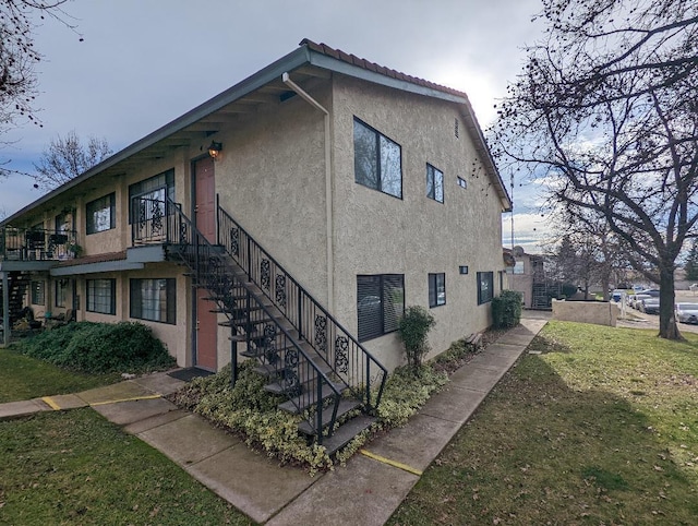 view of side of property with a yard