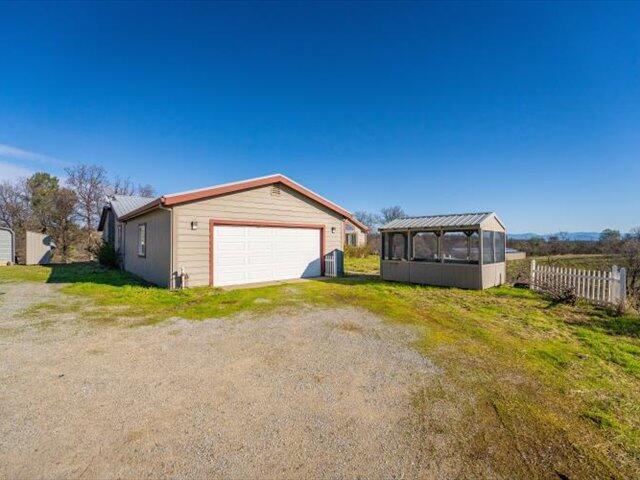 view of property exterior featuring a garage and an outdoor structure