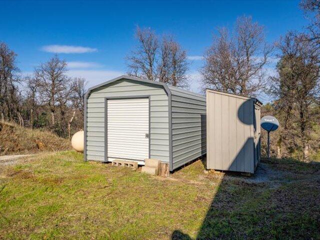 view of outbuilding featuring a yard