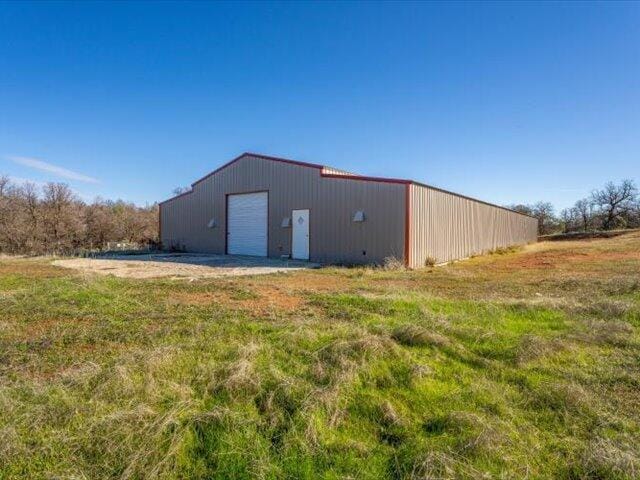 view of outbuilding with a yard and a garage