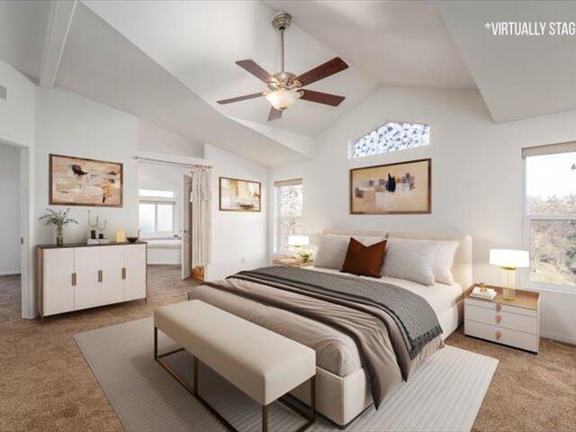 carpeted bedroom with multiple windows, ceiling fan, and lofted ceiling