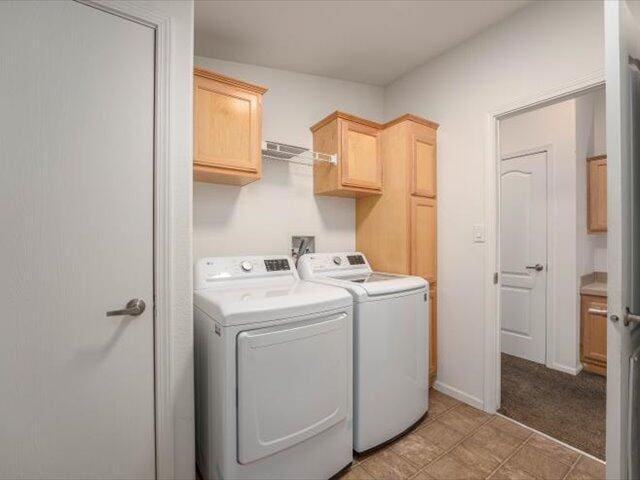 laundry area with washer and dryer, cabinets, and light colored carpet