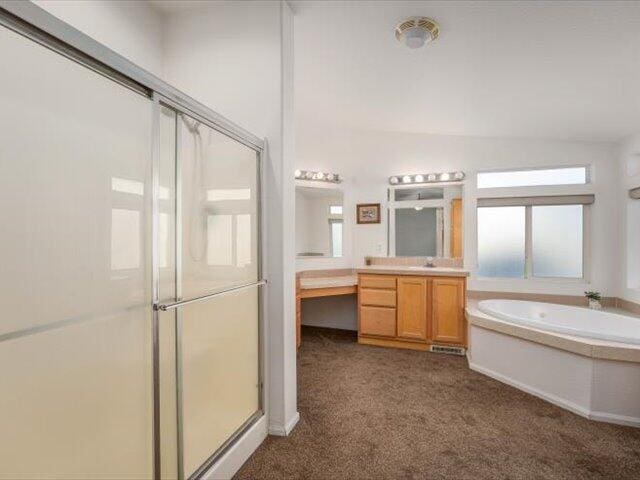 bathroom featuring vanity and plus walk in shower