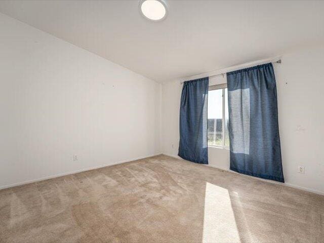 spare room with light carpet