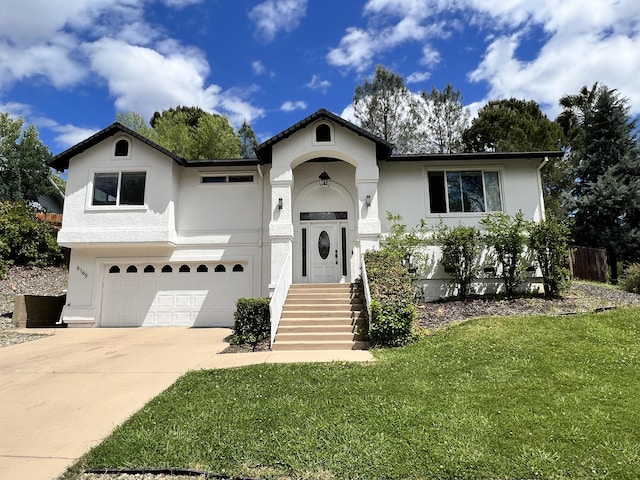 view of front of property featuring a garage and a front lawn