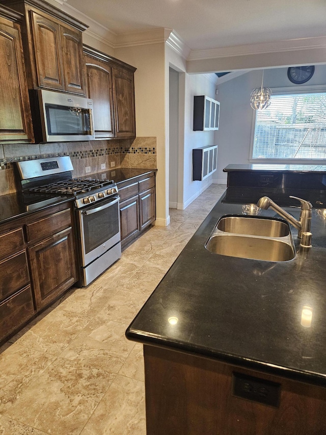 kitchen featuring sink, tasteful backsplash, a notable chandelier, dark brown cabinets, and appliances with stainless steel finishes