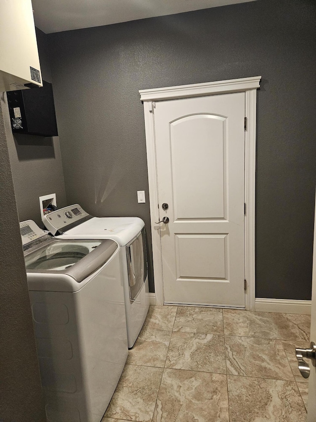 clothes washing area featuring washer and dryer