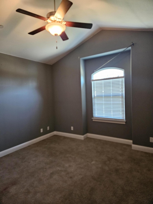 carpeted spare room with ceiling fan and lofted ceiling