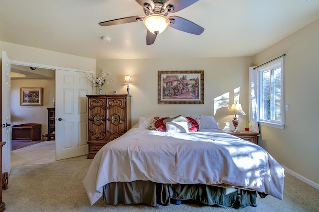 bedroom featuring light colored carpet and ceiling fan