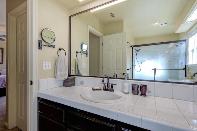 bathroom with vanity and a shower