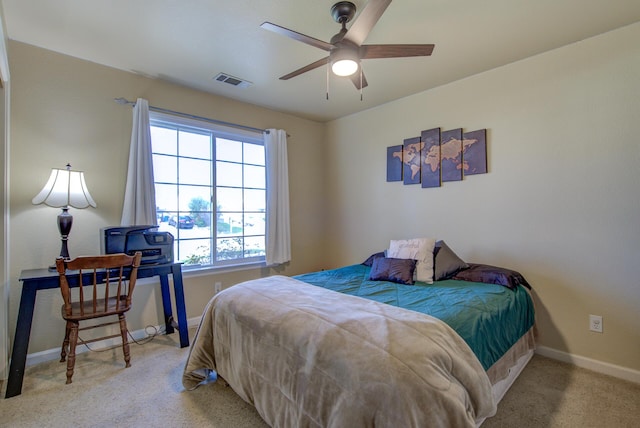 bedroom featuring light carpet and ceiling fan